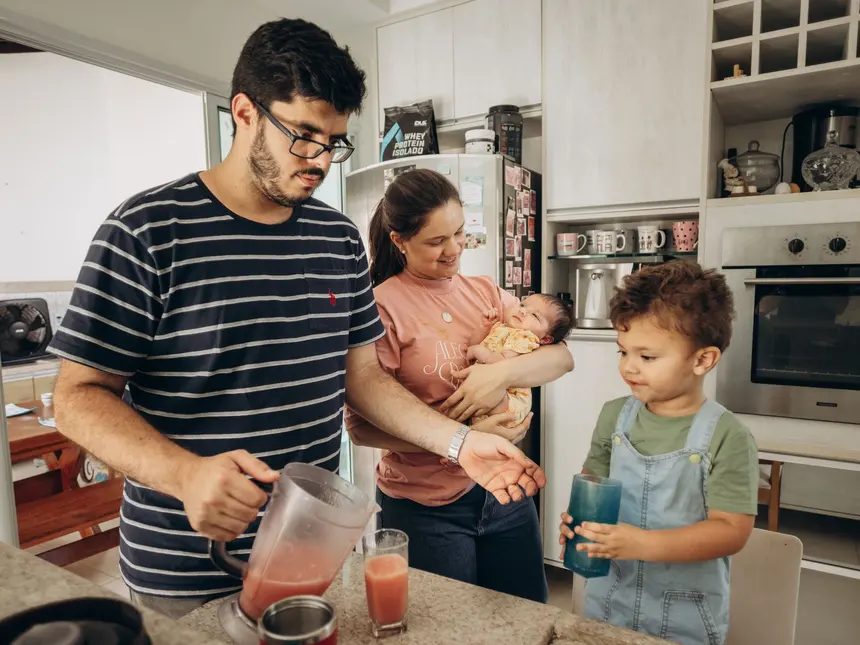 Parents and their children together in the kitchen at home